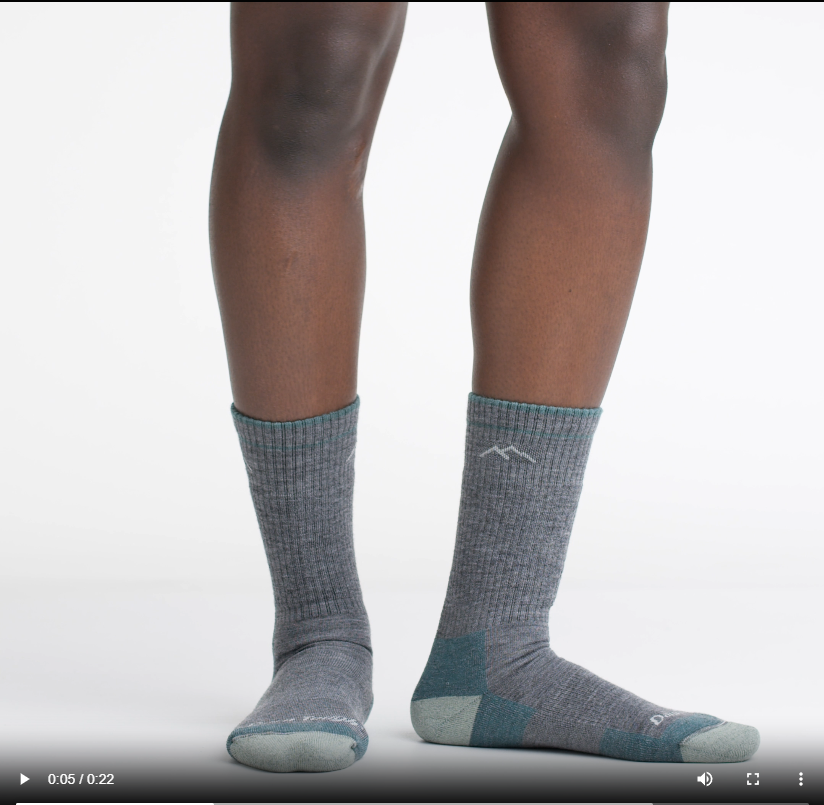 Video of model wearing hiker boot socks in slate, rotating their feet to show the fit of the socks.