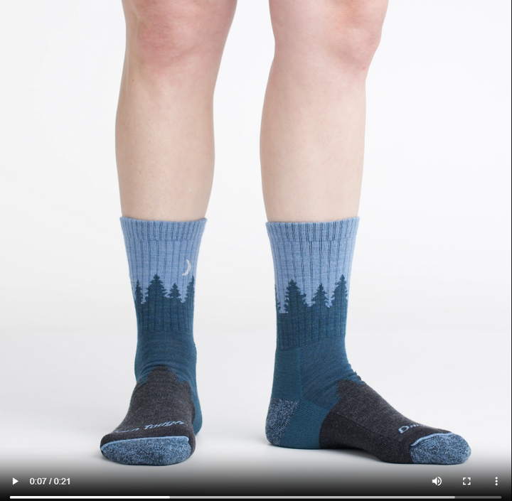 Video of model wearing treeline micro crew socks in blue, showing a 360 degree view of the socks.