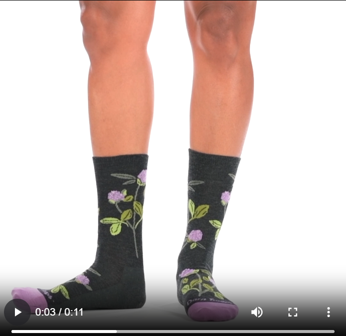 Video of model wearing Lifestyle crew socks in charcoal, rotating around to show the fit of the socks.