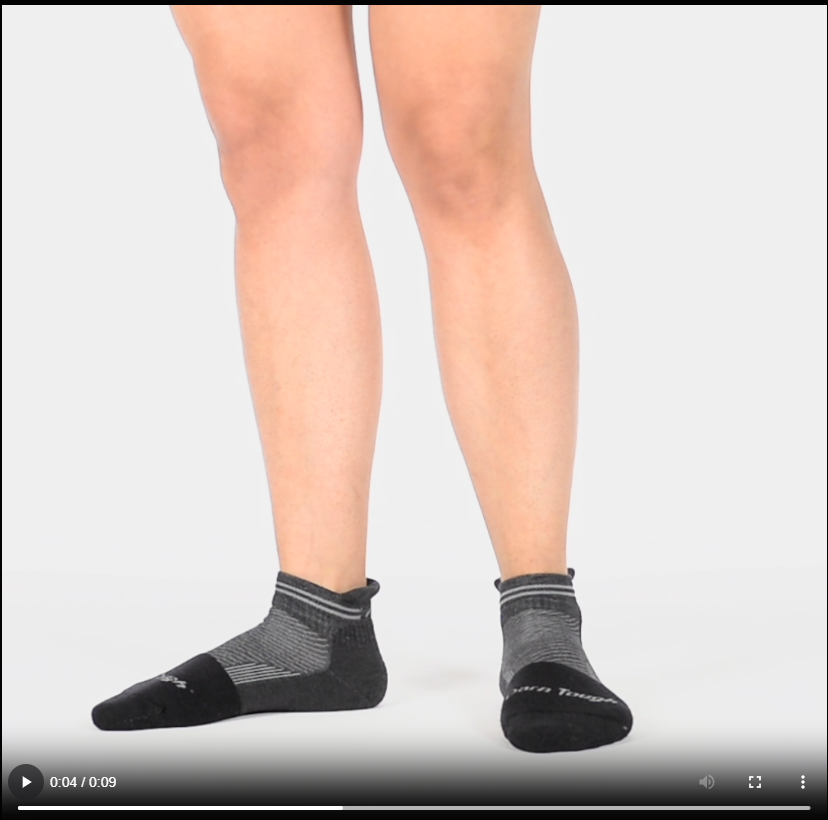 Model walking in the 2210 no show steely sock in gravel