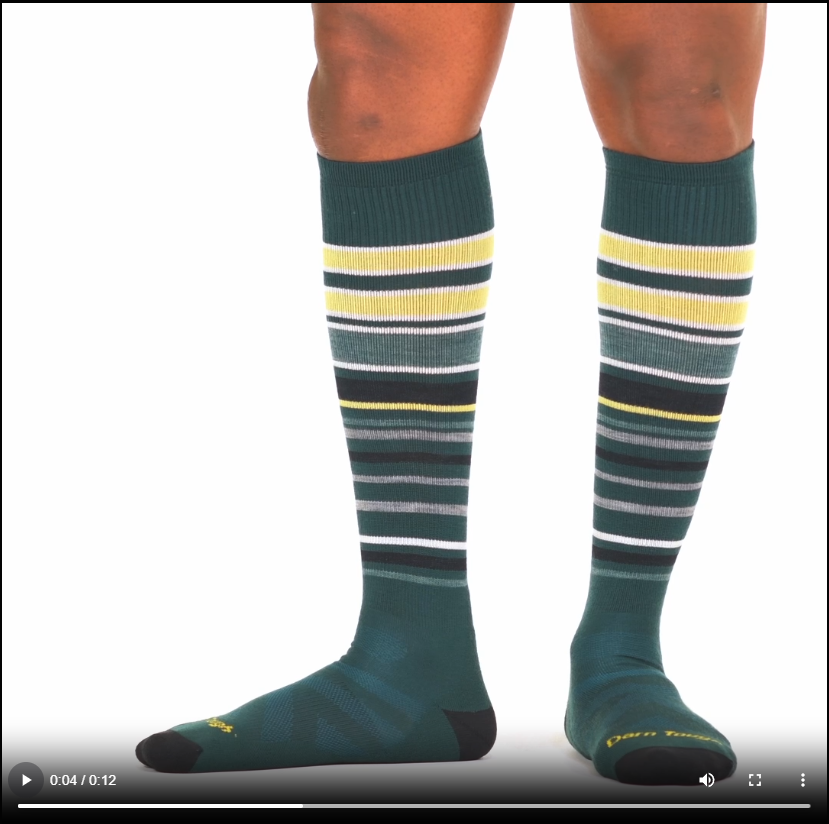 Model walking in the 8017 snowpack over the calf in pine