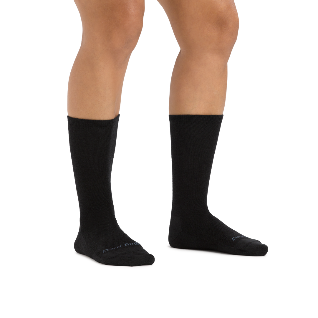 Studio shot of model wearing the women's solid basic crew lifestyle sock in black